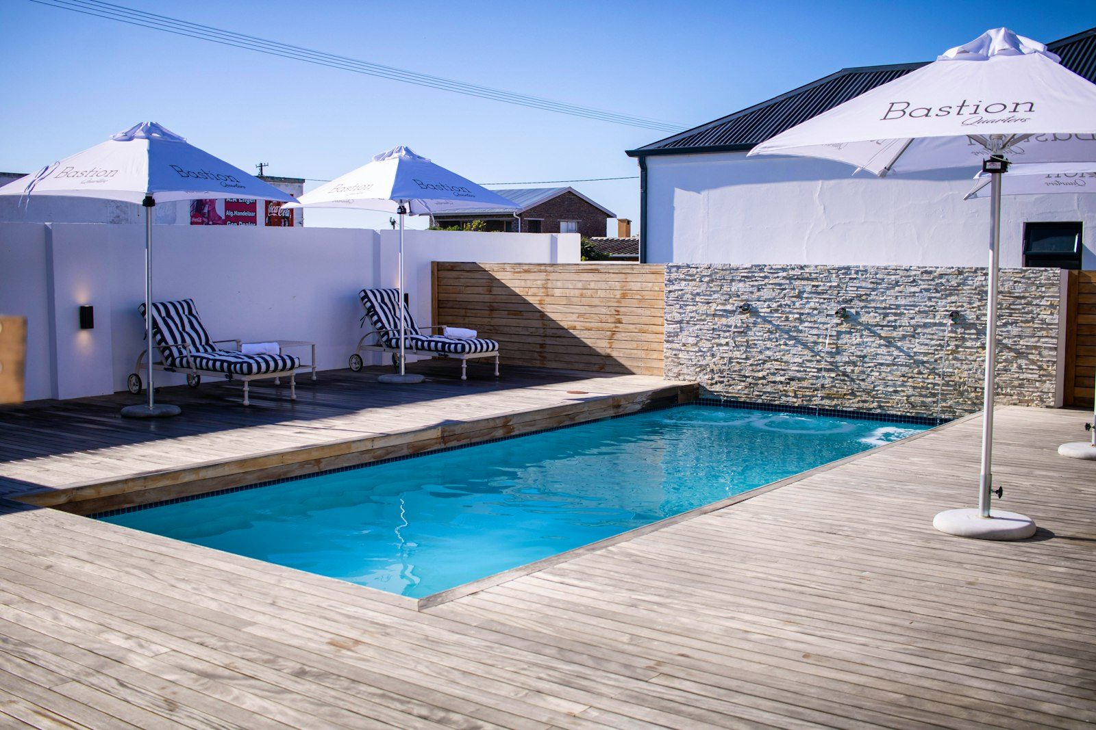 Pool with sun loungers and umbrellas