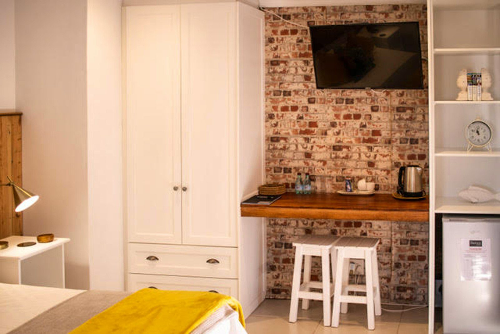 Room with brick feature wall and tea and coffee station